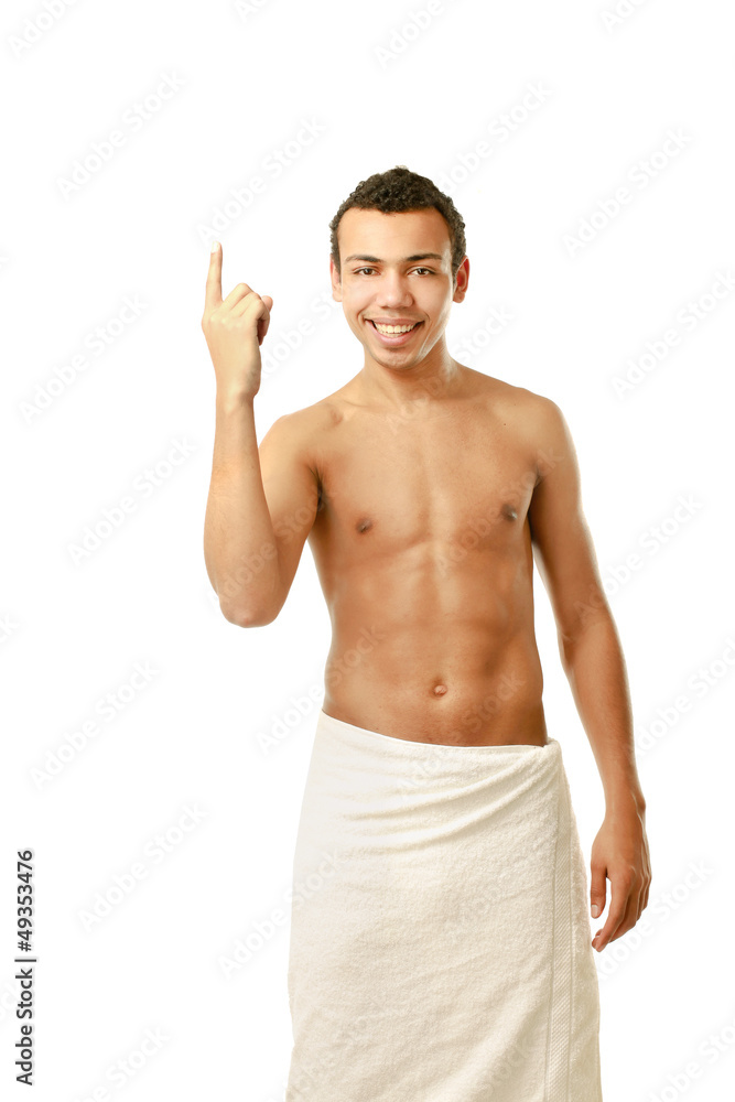 Fototapeta premium A nude young man covering himself with a towel
