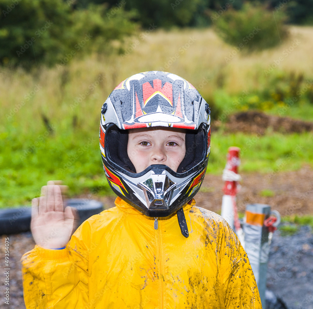 happy boy with helmet at the kart trail happy boy with helmet at the kart trail