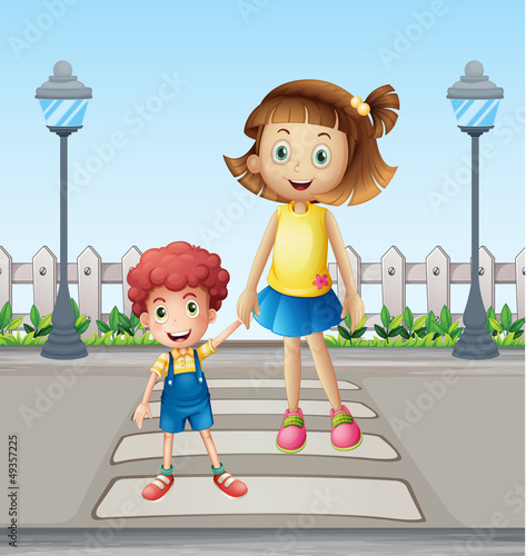 A little child and a girl crossing the pedestrian