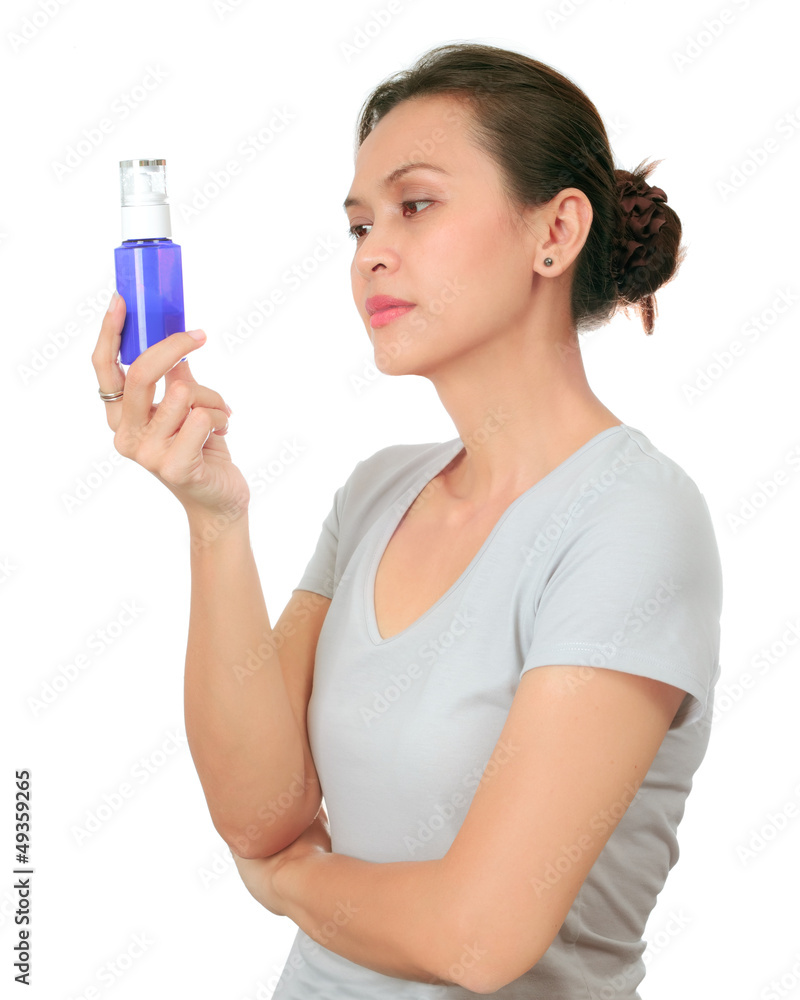 Isolated middle age asian woman with cosmetic cream Isolated middle age asian woman with cosmetic cream