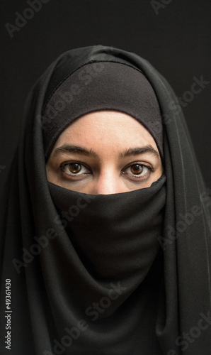 woman in burka over dark background photo
