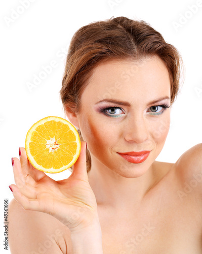 Beautiful young woman with bright make-up, holding orange,