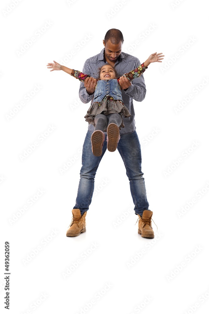 Ethnic man playing with little daughter having fun Ethnic man playing with little daughter having fun