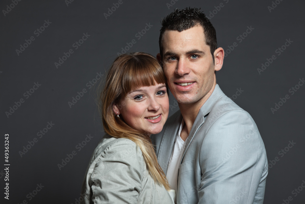 Young couple man and woman in love. Studio shot.