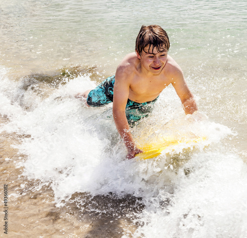 happy boy enjoys surfing in the waves © travelview