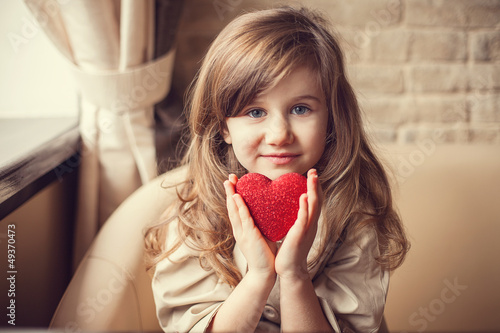 Valentine's Day -  dreaming cute child with red Heart in hands