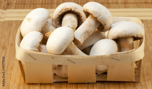 white champignons on a wooden board
