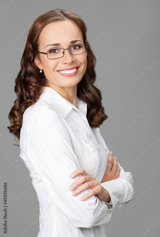 Smiling businesswoman, over gray Smiling businesswoman, over gray