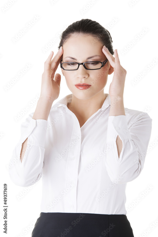 Businesswoman with a headache holding head Businesswoman with a headache holding head