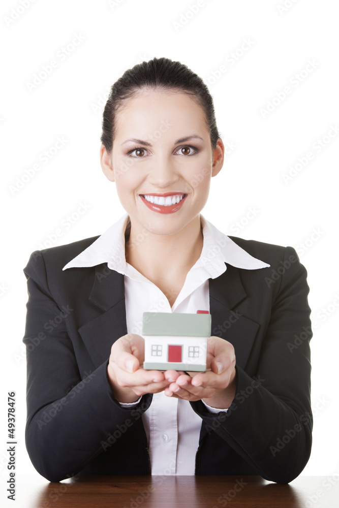 Businesswoman with house model over white Businesswoman with house model over white