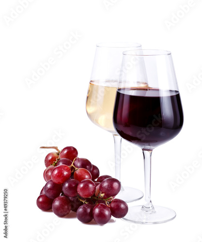 two wine glasses with red and white wine and grapes