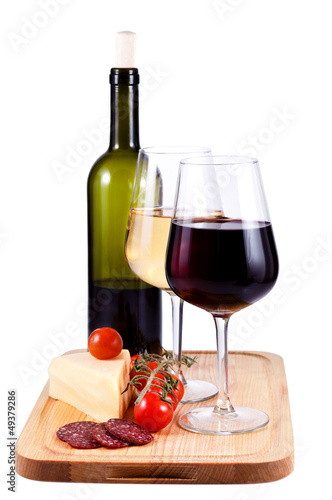 two wine glasses with red and white wine and bottle of wine