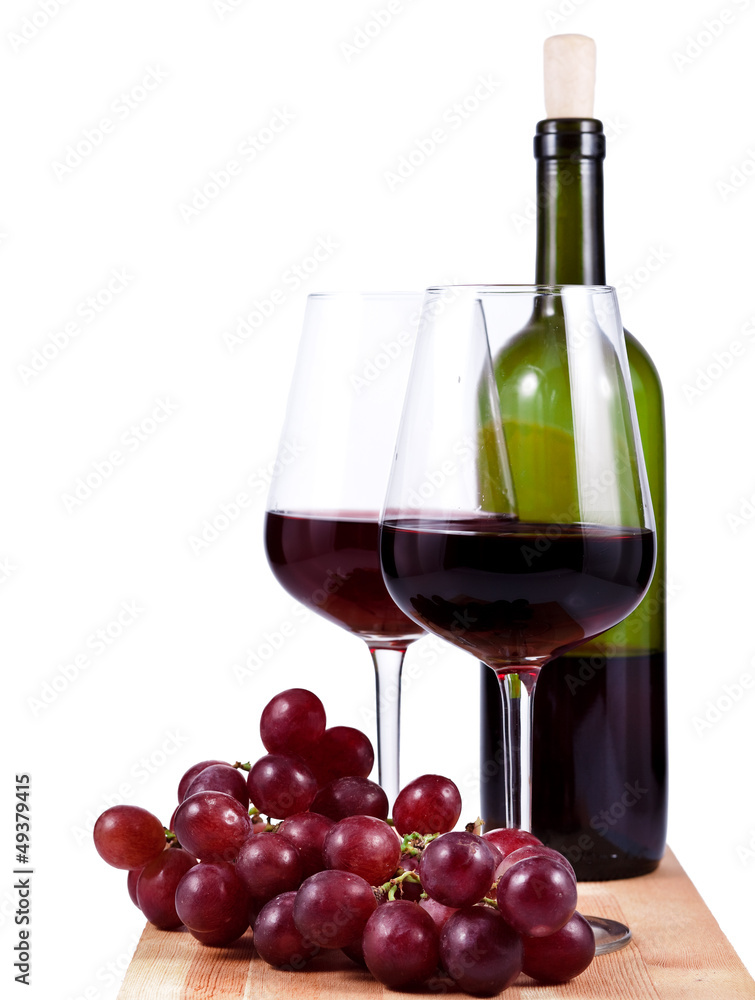 two wine glasses with red wine, bottle of wine and grapes