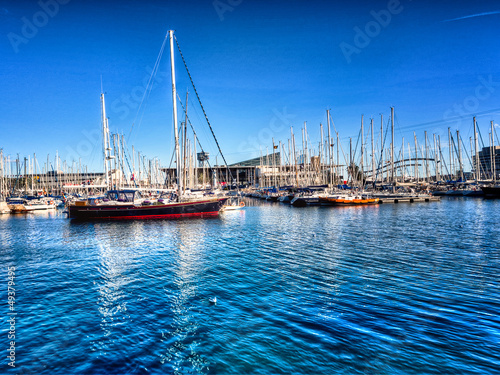 Boats on a marina with blue sky and blue turquoise sea