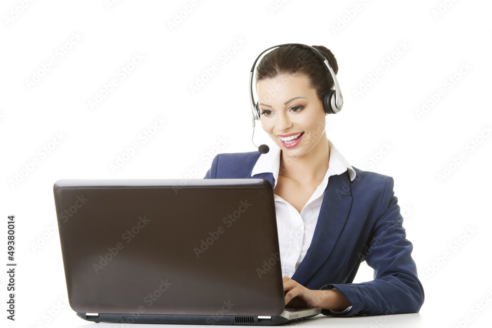 Beautiful young call-center assistant at the desk Beautiful young call-center assistant at the desk