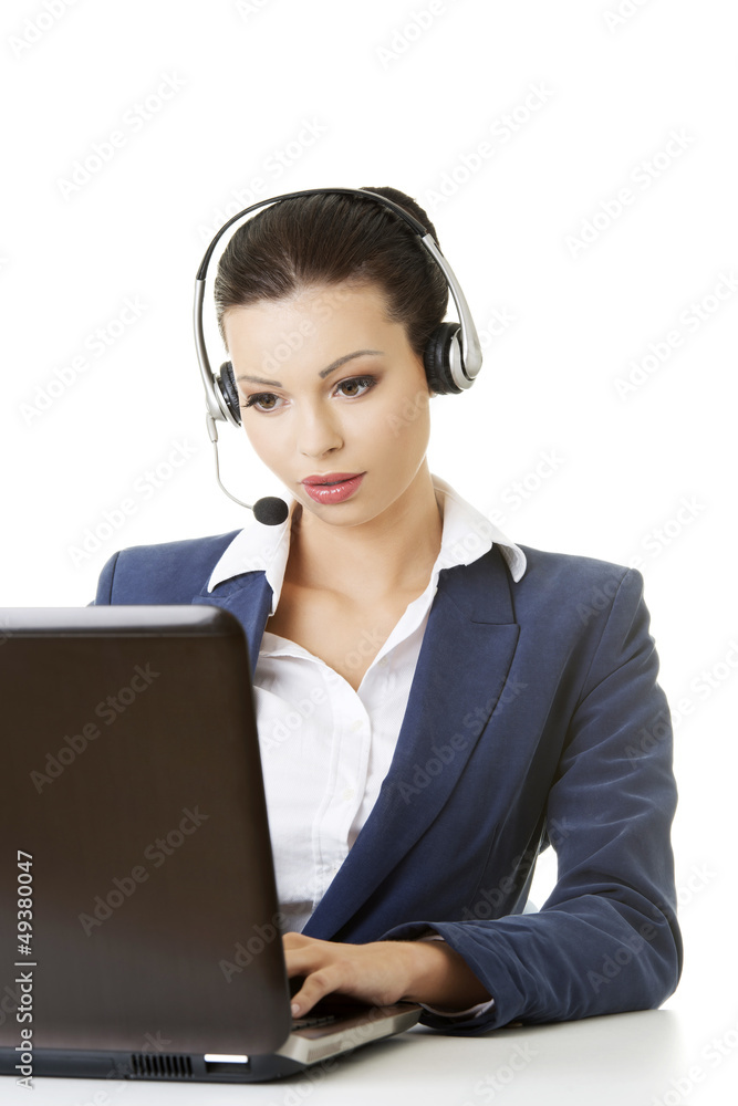 Beautiful young call-center assistant at the desk Beautiful young call-center assistant at the desk