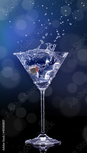 Martini drink splashing out of glass