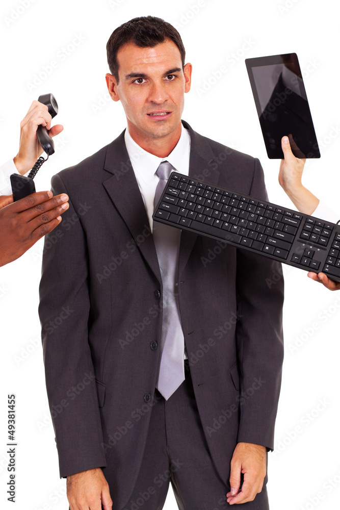 tired male office worker with multiple gadgets around him tired male office worker with multiple gadgets around him