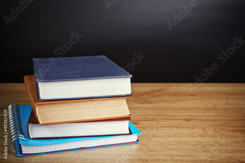 books on wooden deck table and grunge background