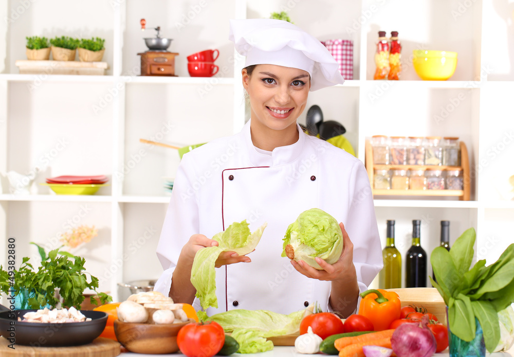 Young woman chef cooking in kitchen Young woman chef cooking in kitchen