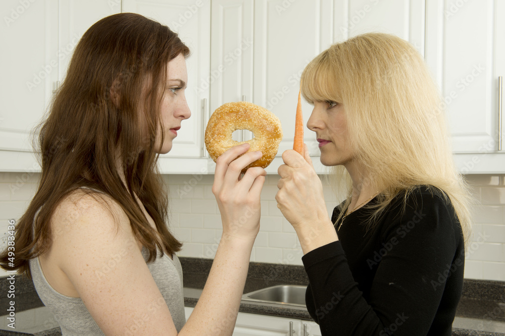 Young woman and mother argue in the kitchen over high glycemic i