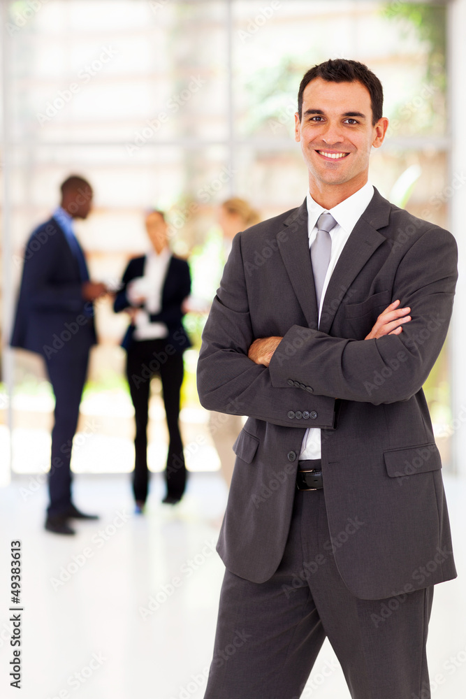 handsome businessman arms folded portrait in office handsome businessman arms folded portrait in office