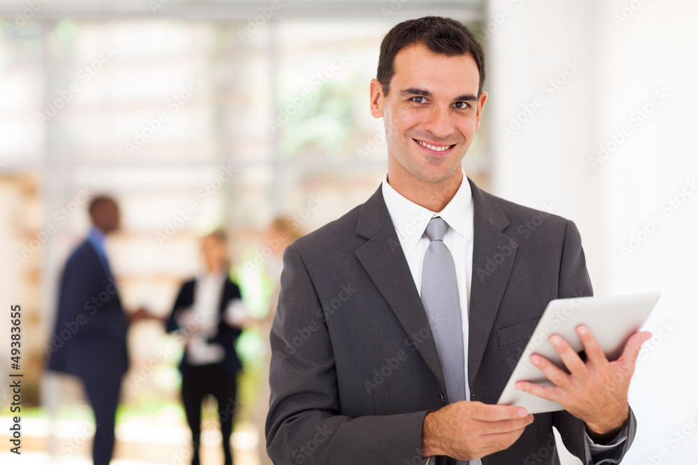 handsome businessman with tablet computer in office handsome businessman with tablet computer in office