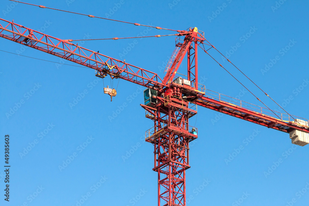 Tower crane on blue sky background.