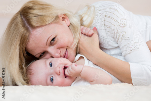 mother playing with  baby b...