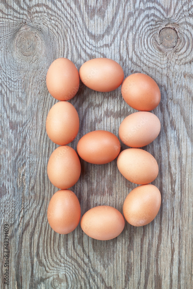 A letter b from the eggs for easter. On a wooden texture. A letter b from the eggs for easter. On a wooden texture.