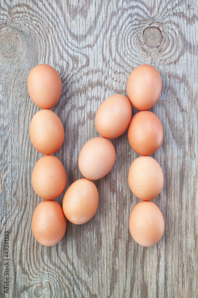 A letter n from the eggs for Easter. On a wooden texture. A letter n from the eggs for Easter. On a wooden texture.