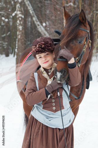  woman keeps the Arab racer in  brown riding habit © Shchipkova Elena
