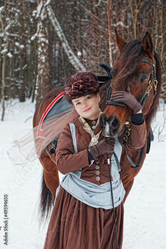  woman keeps the Arab racer in the brown riding habit