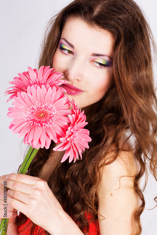 Girl with gerbera flower in studio