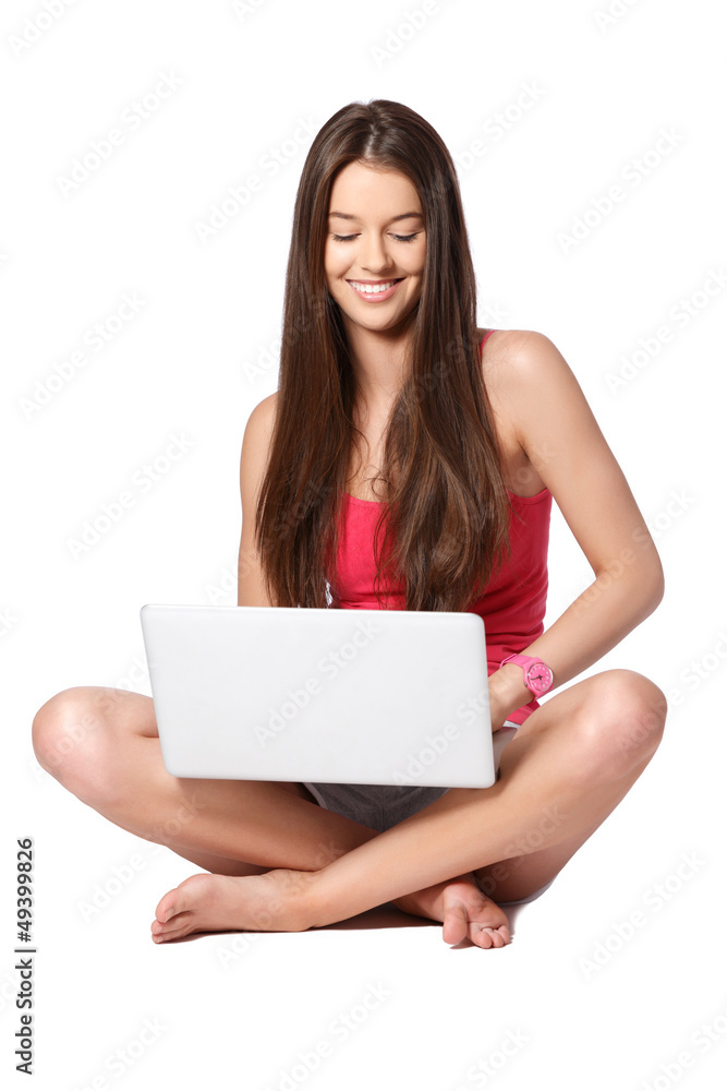 happy teenager with laptop sitting on white background happy teenager with laptop sitting on white background
