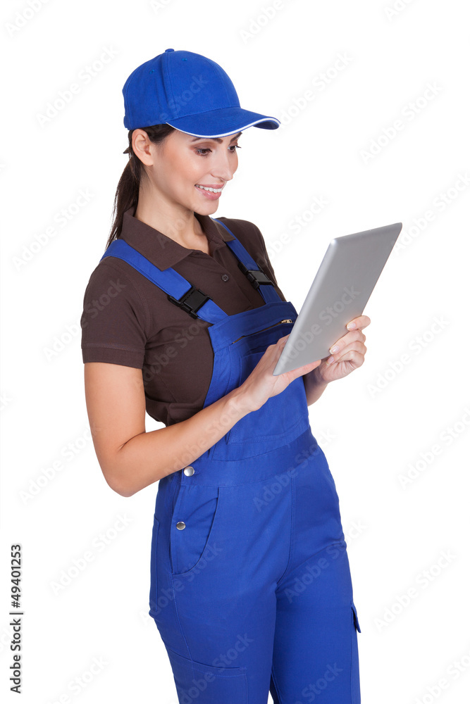 Smiling Female Plumber Working On Digital Tablet Smiling Female Plumber Working On Digital Tablet