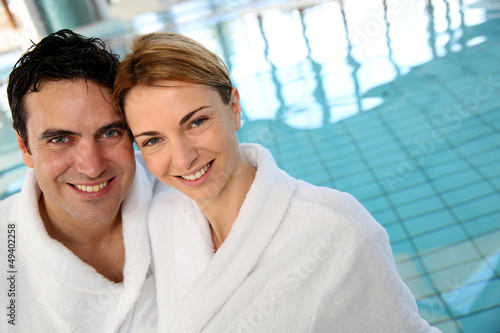 Portrait of couple in bathrobe standing in spa center