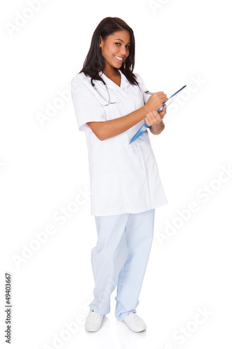 Female Doctor Writing On Clipboard