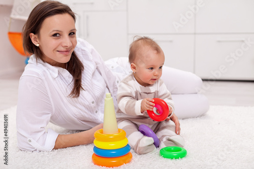 Baby girl and her mother playing
