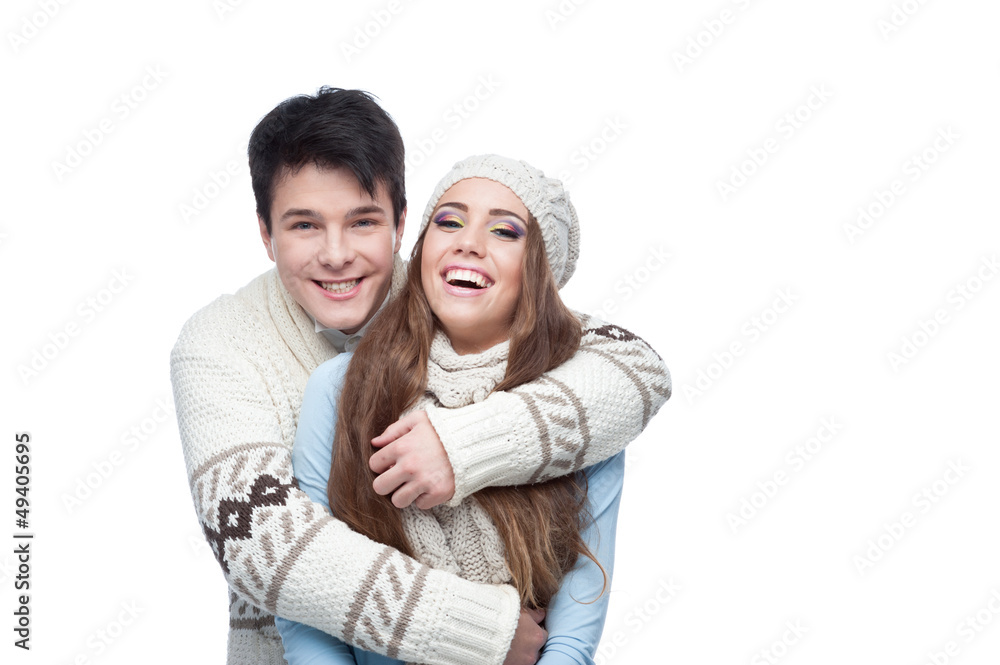 young smiling couple in winter clothing embracing young smiling couple in winter clothing embracing