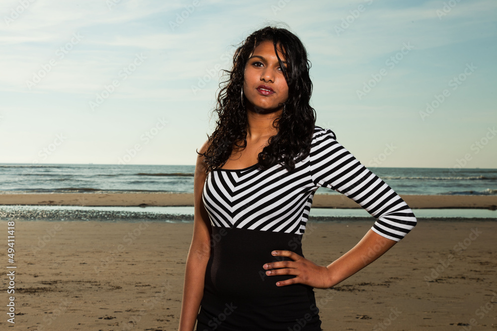 Pretty indian girl with long hair on the beach in summer. Pretty indian girl with long hair on the beach in summer.