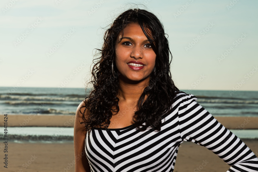 Pretty indian girl with long hair on the beach in summer. Pretty indian girl with long hair on the beach in summer.
