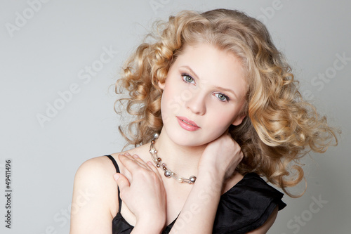 Young blonde girl posing in studio