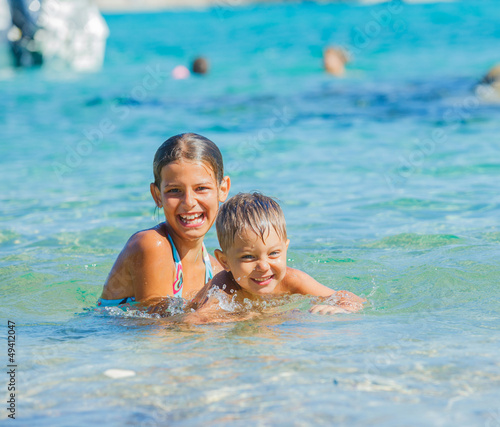 Kids playing in the sea © Max Topchii