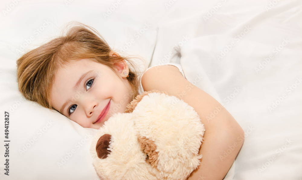 Adorable little girl in the bed
