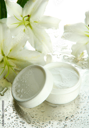 Fototapeta Naklejka Na Ścianę i Meble -  Cosmetic cream and beautiful lily, close up