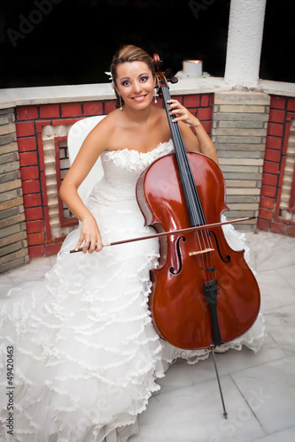 Bride musicial playing cello photo