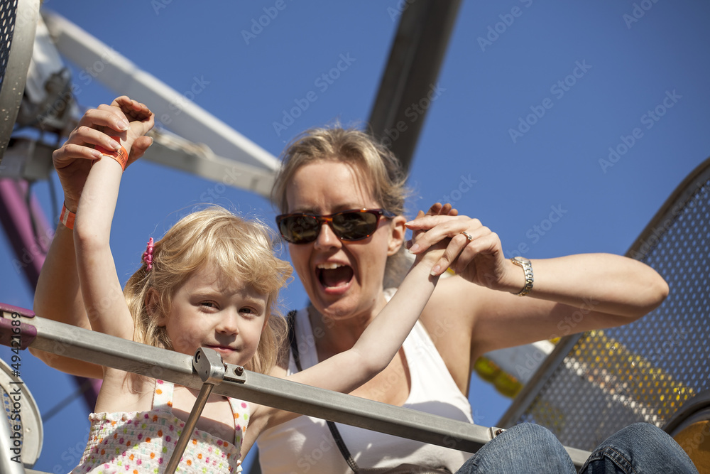 Mother and Daughter on a Ride at the Amusement Park
