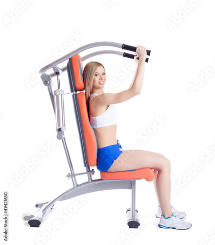 Blonde woman sitting on exerciser photo