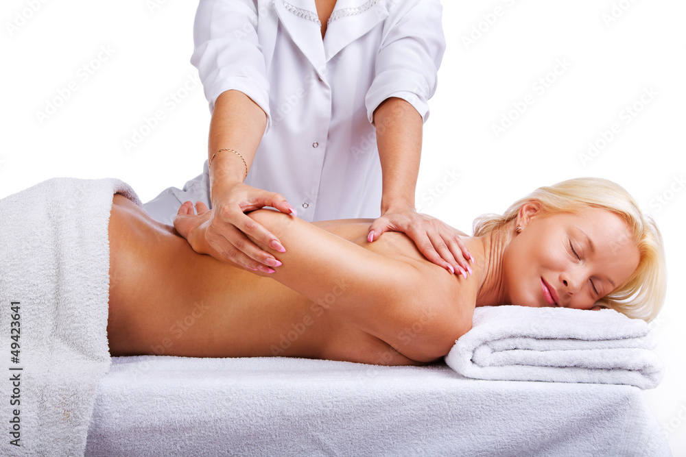 Therapist massages clients shoulder area Therapist massages clients shoulder area